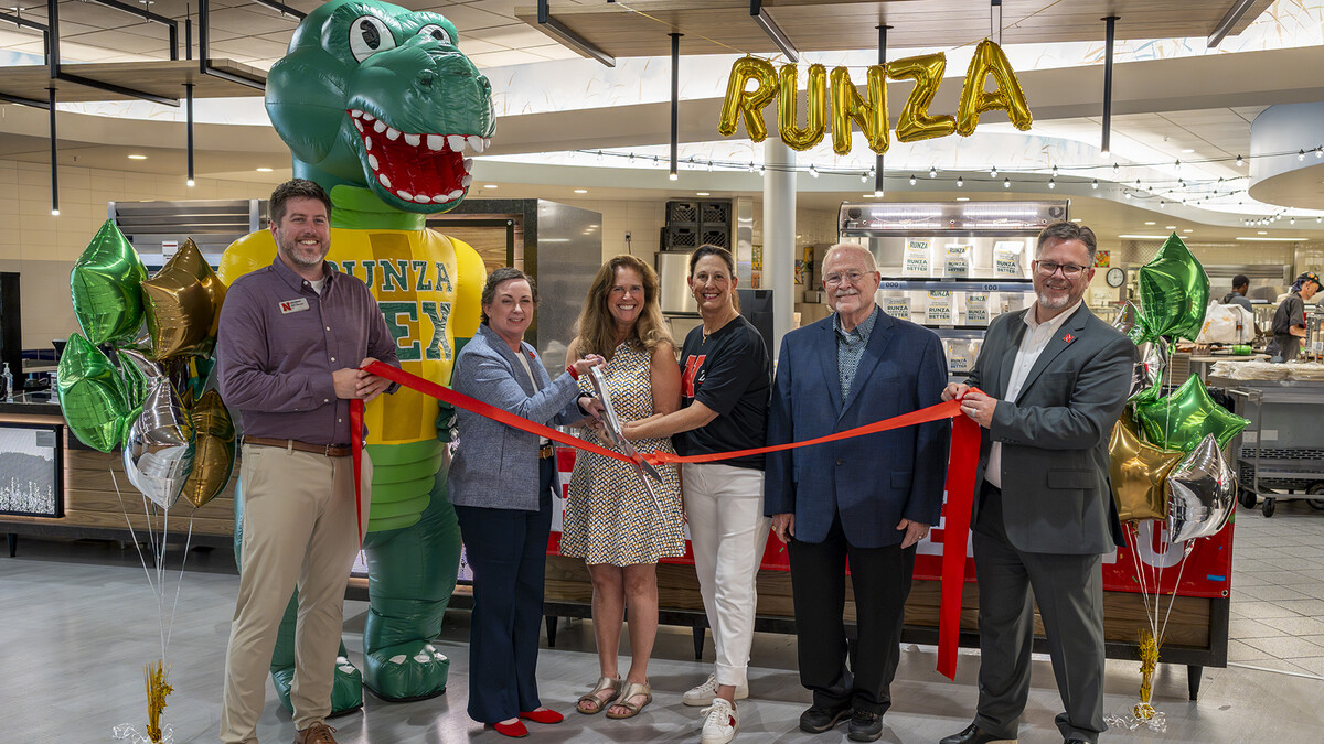 Officials from the university and Runza cut the ribbon at the new location inside Selleck Hall.