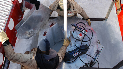 The WISSARD research team set up an ultraviolet light collar at the top of the bore hole in Antarctica.