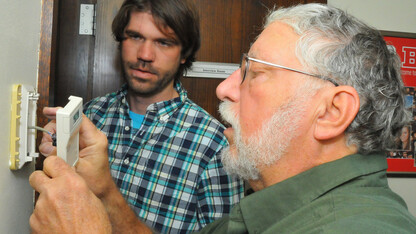 Steve Waltman (right) and Josh Taylor reset a thermostat in the Nebraska Union. Waltman, a building mechanic, retires Oct. 31 after working more than 30 years at UNL. Taylor is taking over for Waltman.