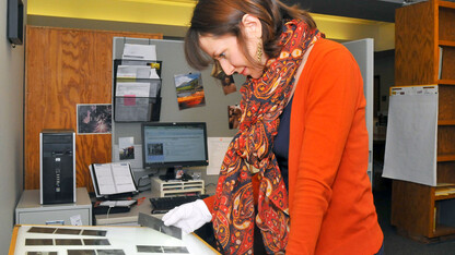 Traci Robison, an archives associate with the University Libraries' Archives and Special Collections, searches film negatives for possible Historypin submissions. UNL has been a contributor to the online historical archive since 2012, posting more than 650 photos.