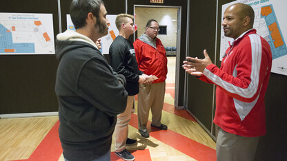 Steve Jara of University Housing (right) talks with (from left) Pat O'Neill, Tiffany O'Neill (partially hidden), Todd Seifert and Josh Seifert during the Nov. 17 East Campus residence hall open house.