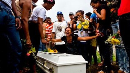 Friends and family mourn the loss of Aneuris Polanco Foxan at Cristo Rey Cemetery. In order to bury Foxan the family had to exhume Smiley Danni Foxan. "We don't have the space and money for another niche," said Hector Williams Foxan.