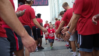 Nebraska athletes greet participants in the Nebraska Football Road Race. The seventh-annual event is July 14.