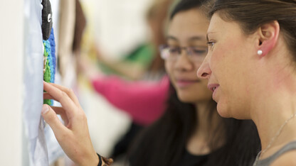 Students examine tactile art pieces they created to be displayed at the Nebraska Center for the Education of Children Who Are Blind or Visually Impaired.