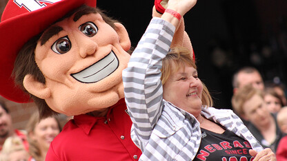 A Husker fan dances with Herbie during a Nebraska Alumni Center Football Fridays event. The 2015 series begins Sept. 4 at UNL's Wick Alumni Center.