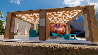 Civana Cruz peering through miniature-scale pavilion