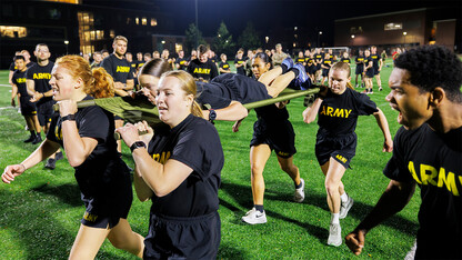 Army ROTC cadets carry a fellow cadet on a stretcher