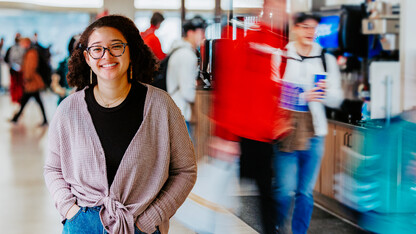 Maya stands in front of the lunch crowd at Selleck Dining Hall,