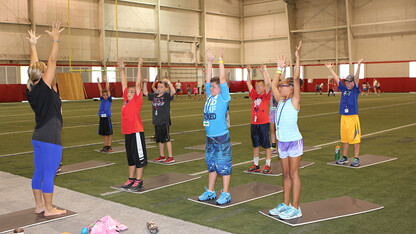 Husker Kids take part in a stretching activity as part of Campus Recreation's summer camp. The program is now in its 25th year, having shown more than 6,920 children the benefit of living an active lifestyle.