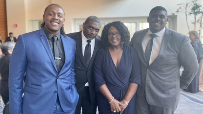 Charlie Foster poses for a photo with her husband and two sons.