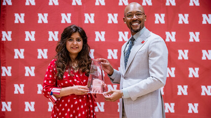 Ritu Jadwani accepts the Promising Leader: Graduate/Professional Student award from Marco Barker, vice chancellor of diversity and inclusion.