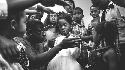 Members of the New Life Tabernacle congregation pray over Josnika Adult, 5, on Oct. 22, 2017, in Belle Glade, Florida.