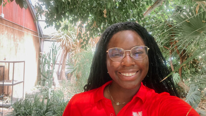 Sule poses in her Rural Fellows shirt and name tag. 