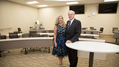 Lisa and Tom Smith, pictured in the Howard L. Hawks Hall classroom they funded, will establish a presidential chair in finance in the College of Business. A presidential chair is among the university’s most prestigious faculty awards and will help to attract and retain top faculty.