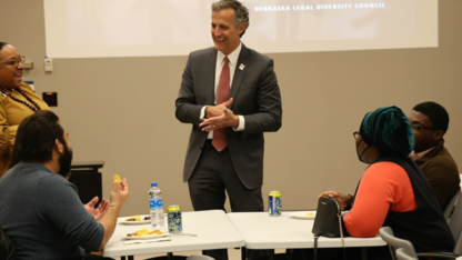 Richard Moberly, dean of law, talks with students during a college event.