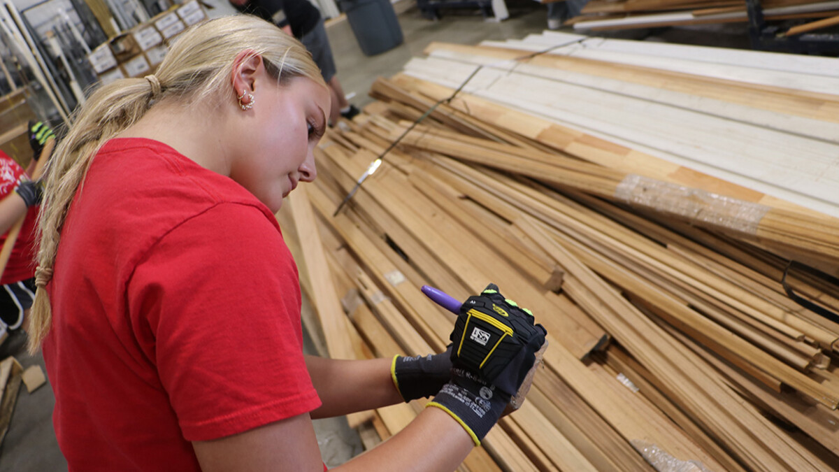 Sierra Little prices lumber at Habitat for Humanity's Kansas City ReStore location.