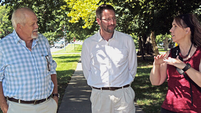 Andries Jordaan (left) and Janse Robie, both of disaster management agencies in South Africa, talk with NDMC climatologist Deborah Bathke during a recent visit to learn about the center's available tools.