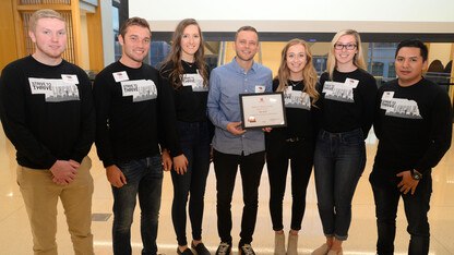 Mary Morton (second from right), Strive to Thrive Lincoln student, and classmates present Andrew Norman (center), executive director of The Bay, with grant award at final ceremony.