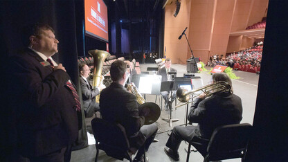 Corrie Svehla (left) watches from backstage as faculty, staff, students and stakeholders file into the Lied Center for Performing Arts. After a disease attacked his kidneys, Svehla is now waiting for a matching donor for a transplant.