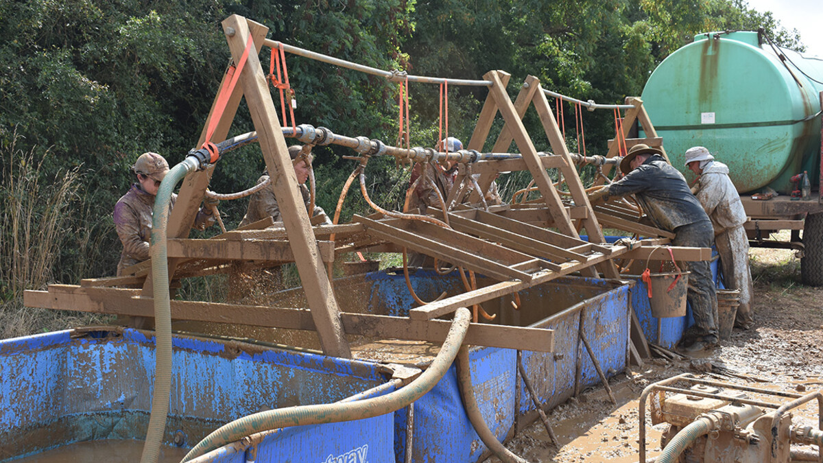 The team used a unique process (wet-screening) to process the very sticky clay sediments to recover possible evidence related to this crash site.