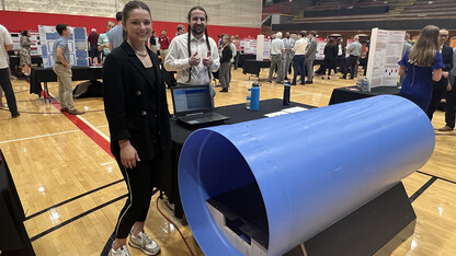 Capstone team members Summer McGrew and Evan Harner display a 6-foot section of the tunnel they designed to replicate the experiences of flight crew members aboard a B-36 bomber.