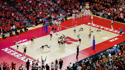 A composite photo showing Nebraska volleyball compete against Wisconsin during the NCAA Volleyball Tournament Regional Final at the Bob Devaney Sports Center.