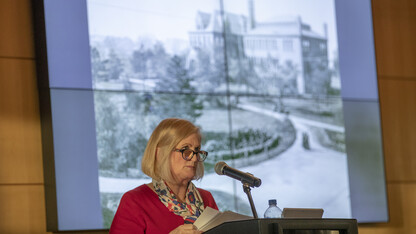 With an image of Architecture Hall — the university's first library — in the background, Kay Logan-Peters, professor of libraries, delivers an N150 Nebraska Lecture at the Champion’s Club on Feb. 12. Nearly 300 attended the event, which featured a historic tour of campus architecture, spanning the university’s first building to the roots of the modern-day campus.