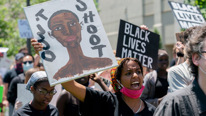 Batool Ibrahim leads protestors in chants as they march from the Nebraska State Capitol to Andersen Hall on June 13.