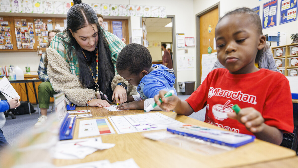 Crandall Blake helps a kindergartener during her student teaching experience at Lincoln's Lakeview Elementary School in December 2023.