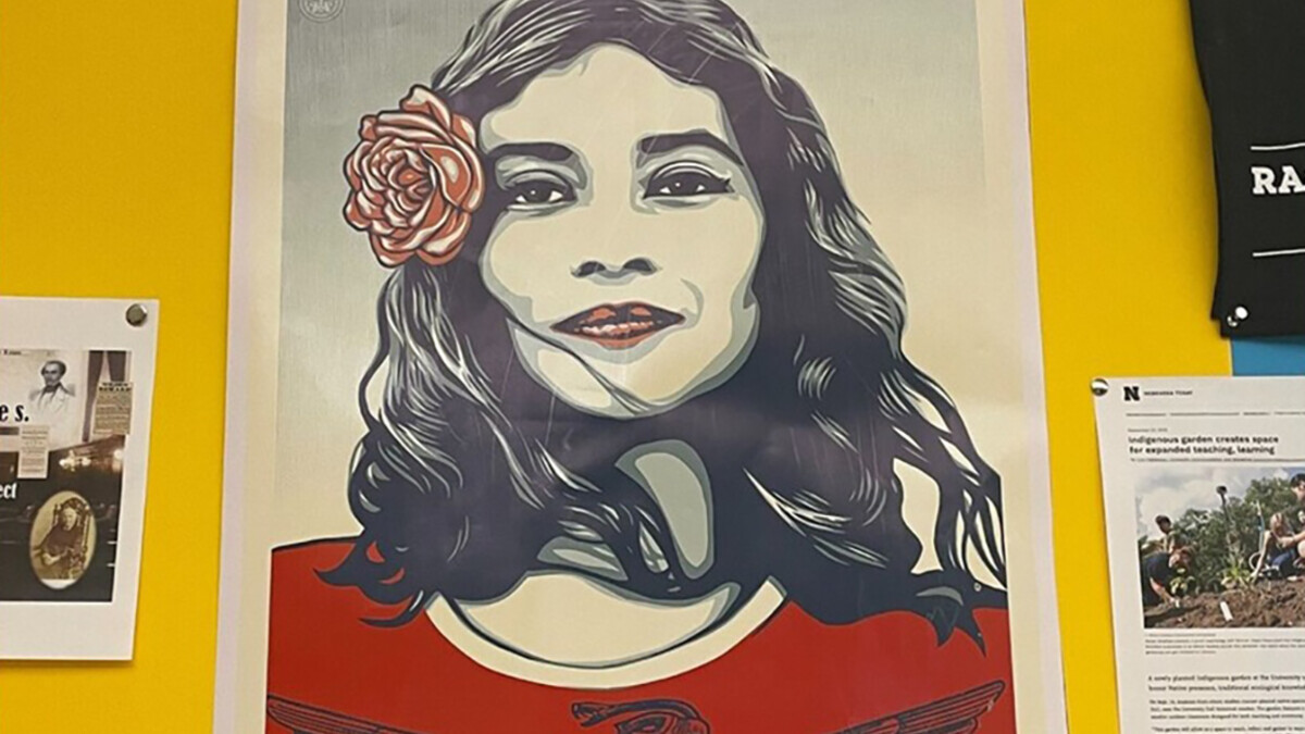 Artwork showing a girl with a flower in her hair is displayed on a bulletin board.