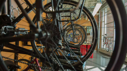 Bikes hang in the Outdoor Adventures Center bike shop. A new community partnership is bringing a bike-share service to campus this spring.