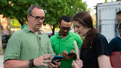 J.B. Tyson (first assistant director, left) visits with Carson School students Adam Turner and Candace Nelson to set up a shot for "The Healing of Harman." Photo by Jordan Opp.