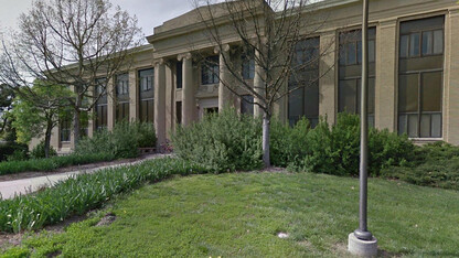 Main entrance to Chase Hall before a redesign of the landscape. Overgrowth made the door and nearby sidewalks nearly invisible to passersby.