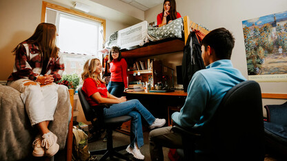 Students hanging out in a residence hall room.