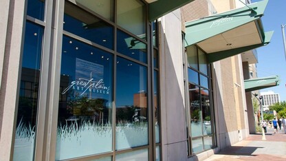 Outside the Great Plains Art Museum, grass continues and is topped by more museum logos.