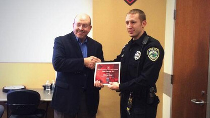 Chief Owen Yardley (left) congratulates Officer Michael Eckel, UNLPD's Officer of the Year.