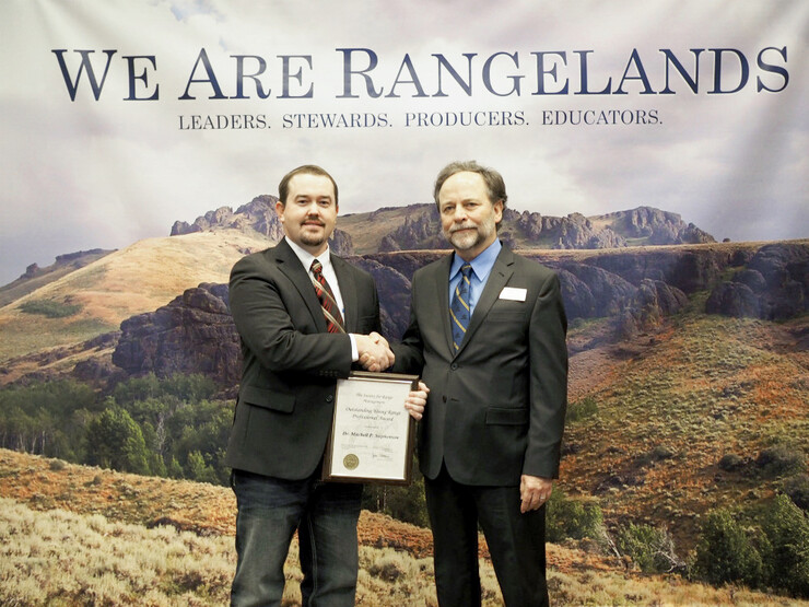 Mitchell Stephenson, left, receives the 2018 SRM Outstanding Young Range Professional Award from SRM 2017 President Larry Howery. Courtesy Photo