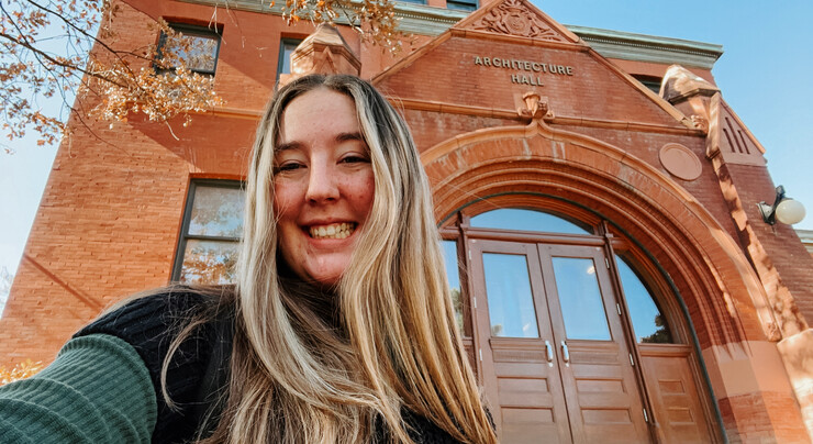 Emily takes a selfie in front of Architecture Hall.