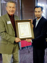 Chuck Hibberd presenting The Honor Society of Agriculture Gamma Sigma Delta Extension Award of Merit to Amit Jhala.