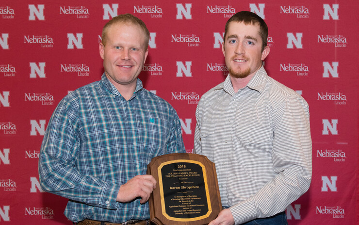 Aaron Shropshire, left, accepts his Teaching Assistant Teaching Excellence Award from Austin Holliday, senior Grazing Livestock Systems major.