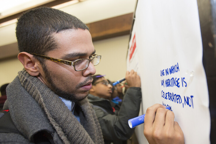 Keith Garcia signs a banner envisioning a better UNL.
