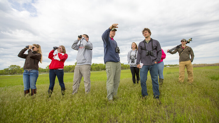 Students in an ornithology course (Biological Sciences 475) walk through the Clear Creek State Waterfowl Management Area on a birding field trip. Hands-on learning opportunities are a hallmark of the university’s award-winning School of Biological Sciences.