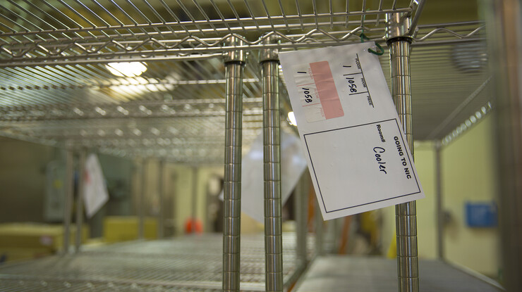 Specialized tags, shown here on shelves in a pilot plant, help inform movers about the final destination of food science and technology boxes and equipment.