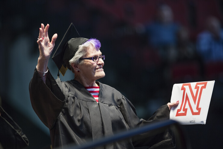 Jean Kops, 87, acknowledges the crowd's applause as she received her degree.