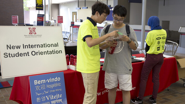 Xu Zhou, a UNL undergraduate and member of the international student welcome team, talks with a new student at the Lincoln airport on Aug. 17. The welcome program was offered at Lincoln and Omaha airports from Aug. 16-18.
