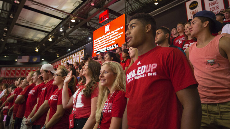 New UNL students (from left) Jennifer Knopik (with hand up), Megan Kaup, Douglas DeBose and Jorge Suarez recite the Husker Pledge during new student convocation held in the Devaney Center on Aug. 21.