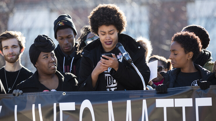 Checking notes on her phone, Maya Evans tears up after discussing her experiences on campus. The presentation was part of the Nov. 19 "Black Lives Matter" rally at UNL. 