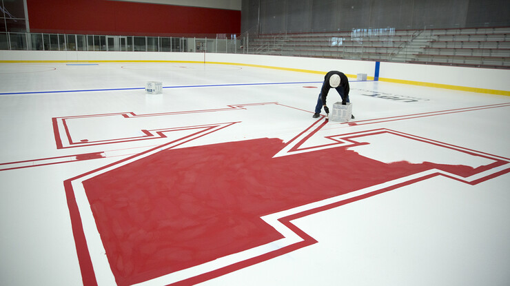 Dan Luedke of R&R Specialties paints the ice in the University of Nebraska–Lincoln's new John Breslow Ice Hockey Center on Dec. 9. The 53,000-square-foot arena, which features an NHL-regulation sheet of ice, is scheduled to open to the public on Dec. 15. Funding for the center started with a $7 million donation from John Breslow, owner and chairman of Linweld.
