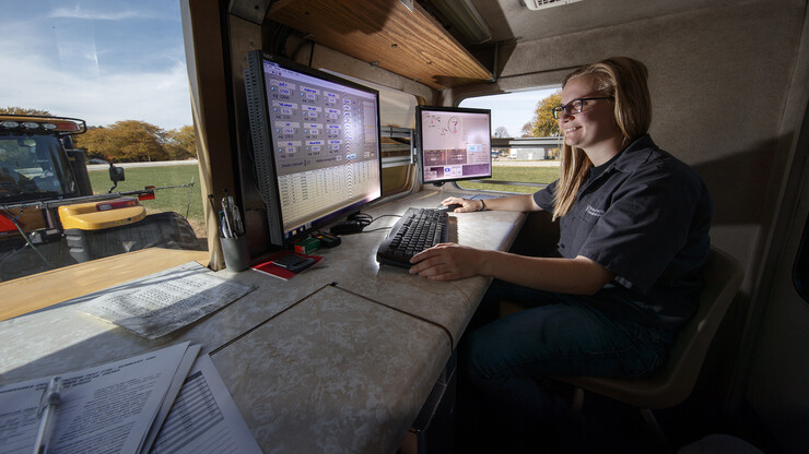 Jordan Bothern, a junior mechanized systems management major, monitors computer readouts in a test car being pulled at the Nebraska Tractor Test Laboratory.