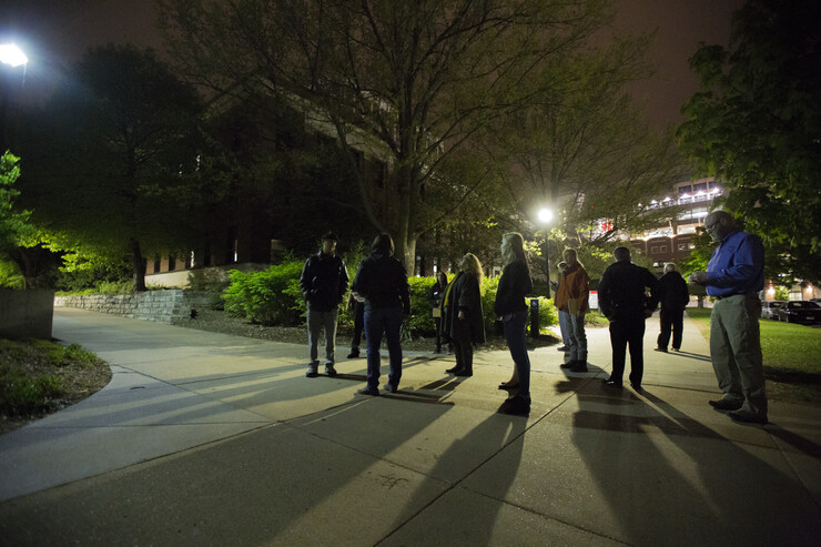 Members of the campus community walk near Bessey Hall during the campus safety walk on April 27.